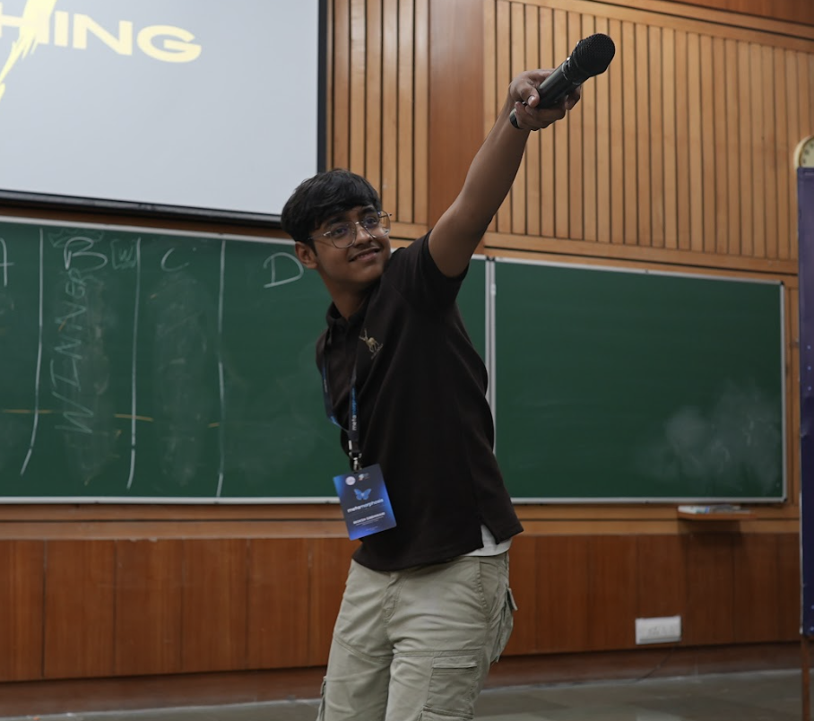 Moksh inviting the audience to speak during an event